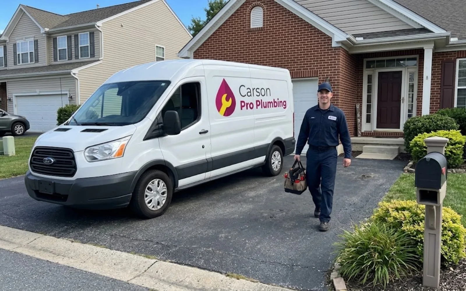 Plumbing service van parked in a residential driveway
