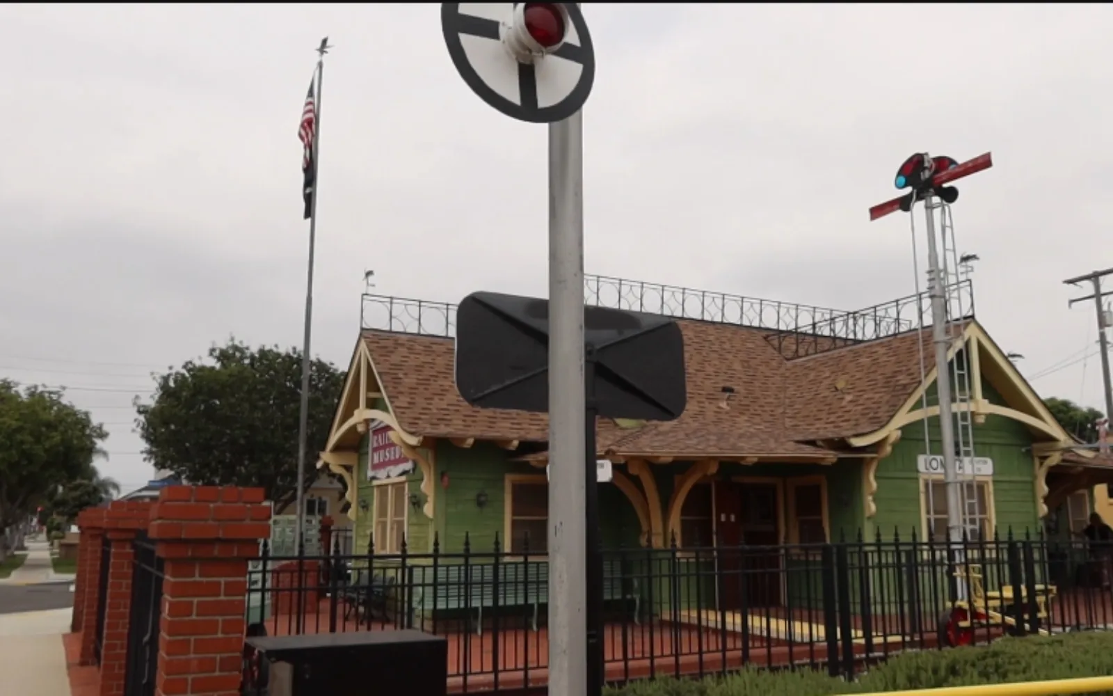 Lomita Railroad Museum, a converted 1900s-style train depot with a real railroad crossing signal out front
