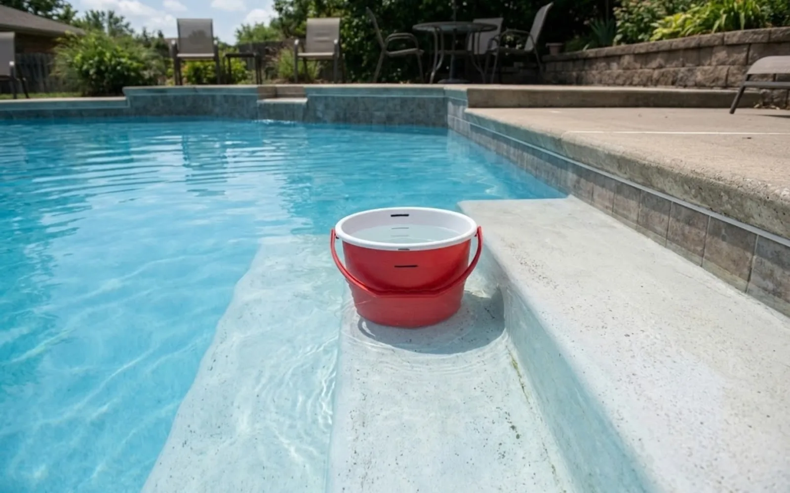 Residential in-ground pool with steps, the setup used for the bucket evaporation test