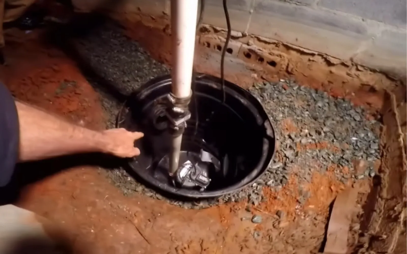 Sump pump and basin installed in a crawl space corner