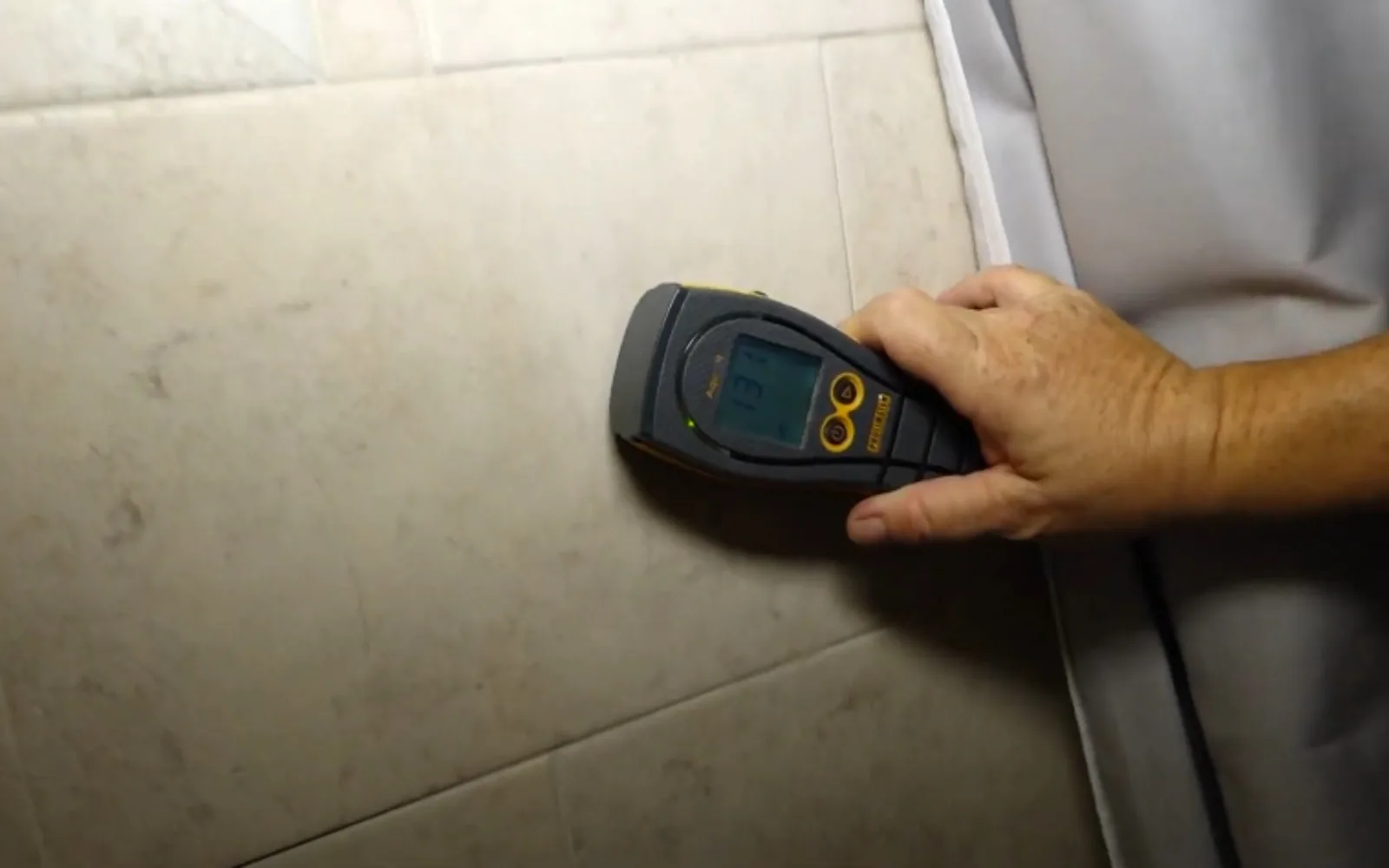 Moisture meter reading being taken on interior drywall